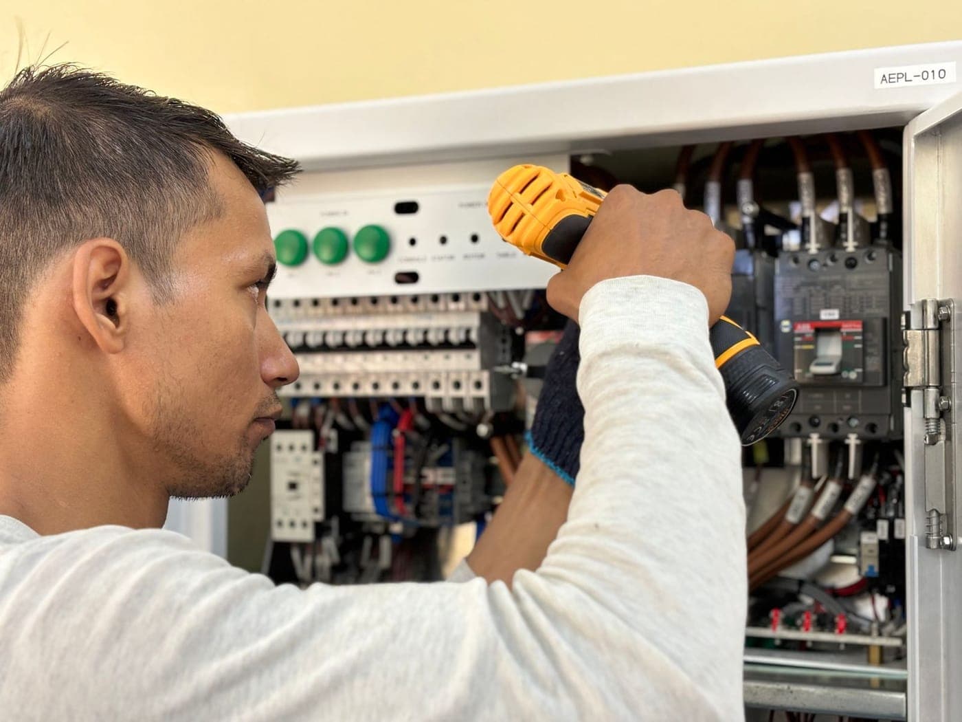 Electrician working on a switchboard panel