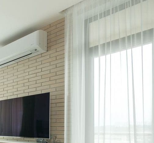 Indoor heat pump unit on a living room wall