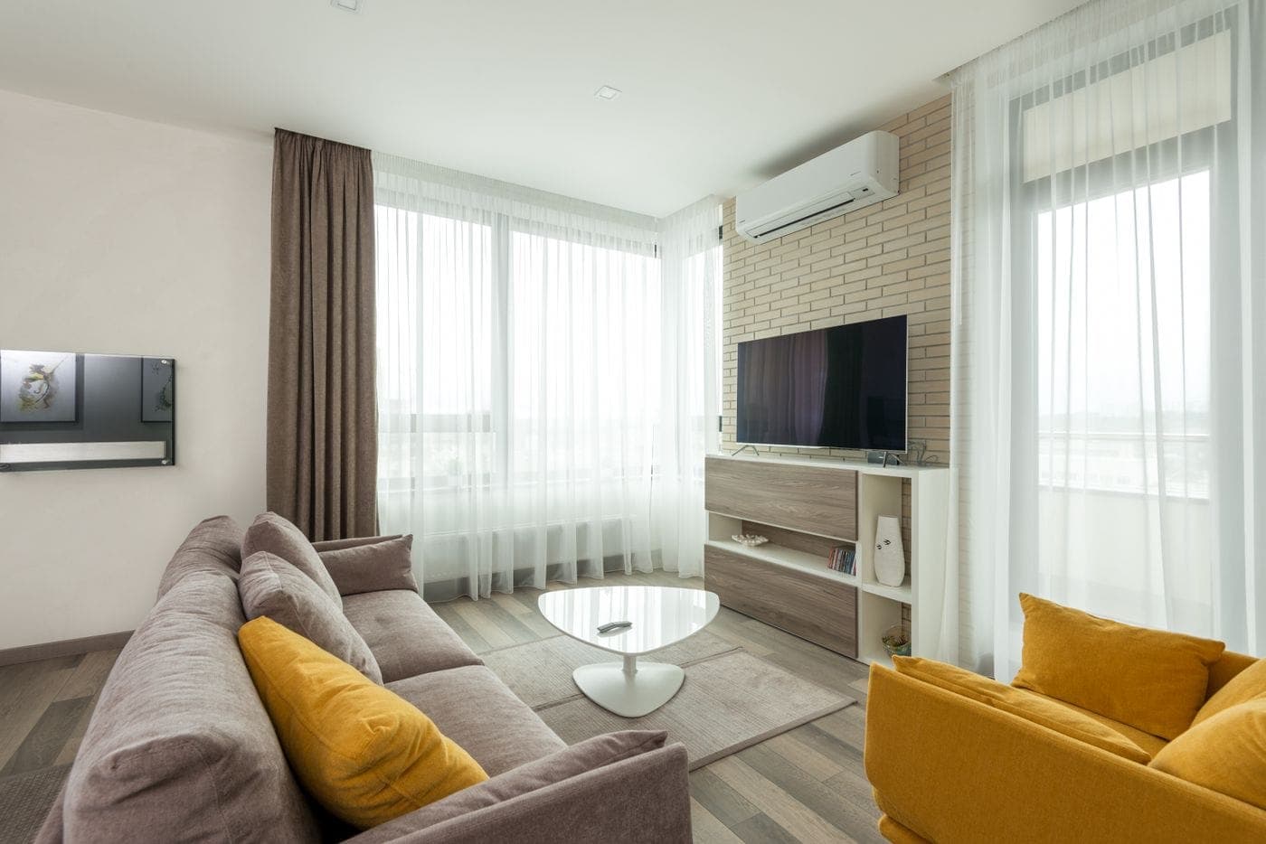 Wall-mounted TV in a tidy living room